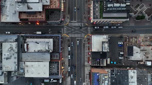 American downtown intersection with cars, crosswalks and surrounding buildings. Urban layout,
