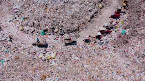 Aerial View of Vast Landfill with Trucks and People