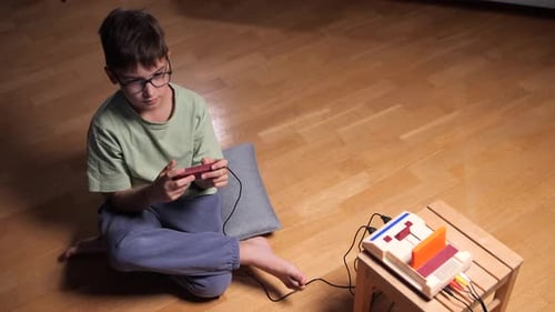 Boy Playing Old-Fashioned Retro Video Game at Home