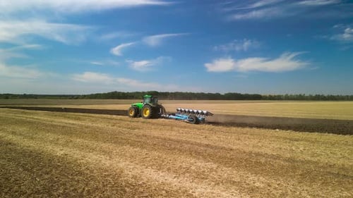 Tractors plowing the field in Ukraine