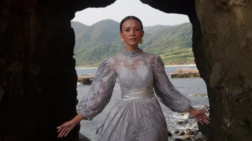 Woman In A Dress Against A Rock Arch
