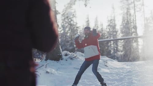 Children Throw Snowballs Amidst Trees Laughter Echoes As Children Engage in Energetic Snow Fight