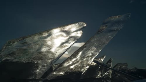 Timelapse of Sunrise Behind Transparent Frozen Pieces of Ice