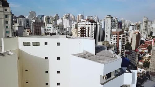 Fly over aerial shot of city centre in afternoon, big buildings and traffic