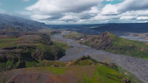 Aerial View of Icelandic Valley with Riverbed and Snow Capped Mountains