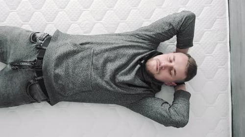 Man Lying Down Relaxing on Mattress
