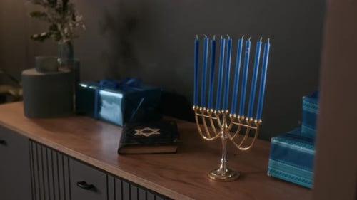 Menorah with Blue Candles and Hebrew Prayer Book