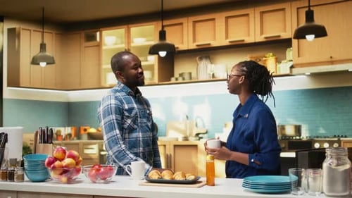Adult Man and Woman Chatting in a Kitchen