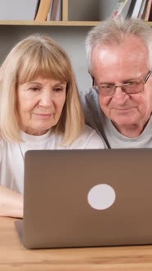Mature Couple Using Laptop Together at Home