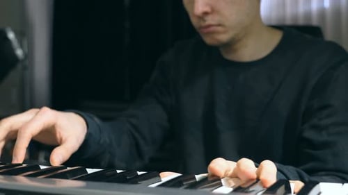 Male Musician Playing at Synthesizer at Sound Recording Studio Young Man Plays Solo of Music Close