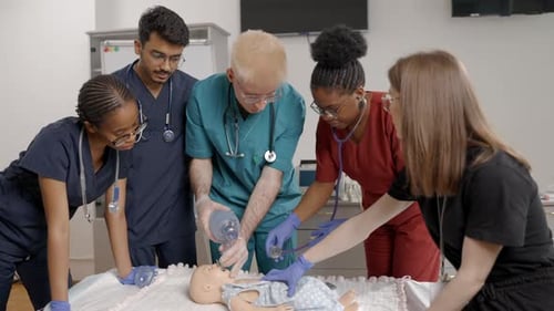 Medical Professionals Perform CPR on Baby Mannequin