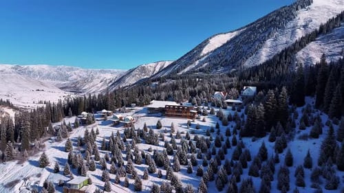 Snowy Mountain Valley Resort Nestled Among Evergreen Trees