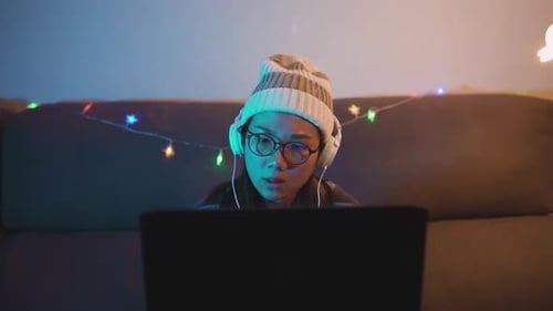 Front view of young asian woman tired of gaming late at night and yawning. Female professional game
