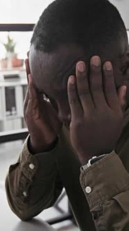 Vertical of Male Employee Having Migraine from Overwork in Office