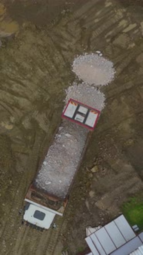 Vertical Video of Heavy Machinery Preparing Ground for New Building Project