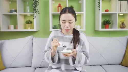 Woman Eating Dessert in Her Living Room