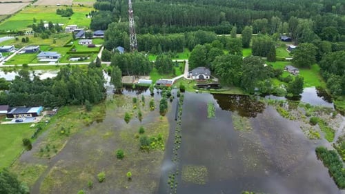 Aerial view of flooded neighborhood with submerged power lines and homes in the area