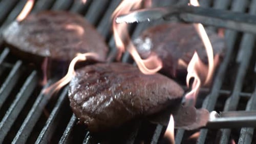 Delicious steak sizzles on a grill in slow motion phantom flex 4k footage