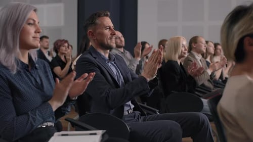 People Applauding in a Presentation at a Conference