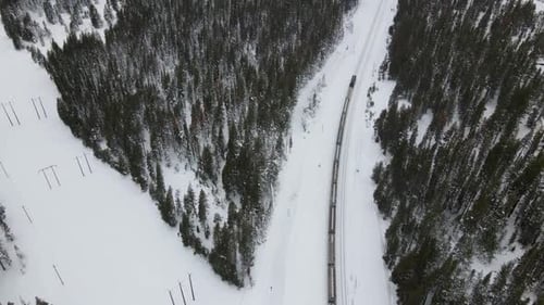 4K Drone Reveal Shot from Train to Snowcapped Mountains
