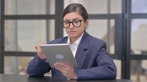 Young Adult Woman Using Tablet in an Office