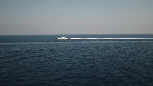 Luxury boat aerial view, luxurious yacht moving fast in blue ocean waters seascape skyline.