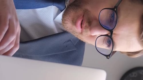 Crazy Surprised and Happy IT Worker A Programmer in a Business Suit Works at a Computer Vertical