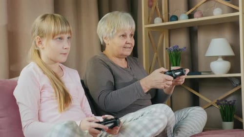 Grandmother and Grandchild Enjoy Playing Video Games Together