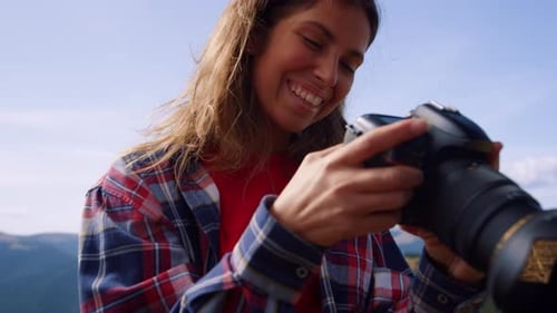 Joyful Hiker with Camera in Summer Mountains