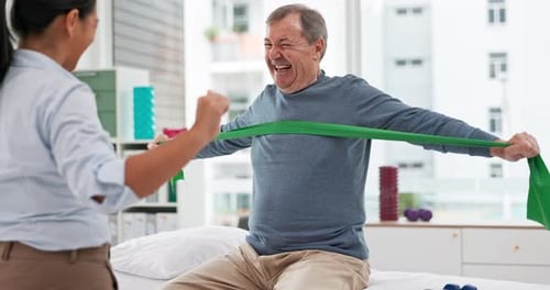 Senior Man Working with Physical Therapist at Clinic