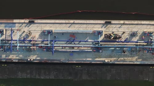 Aerial view of tanker vessel during fuel loading operations at oil terminal