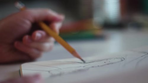 Artist Sketching in Notebook in Studio Space Surrounded by Artist'S Tools, Pencils,