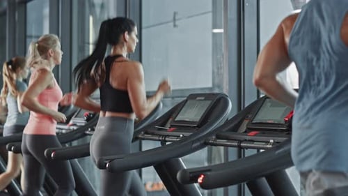 Beautiful Athletic Sports Woman Wearing Wireless Headphones, Listens to a Podcast or Sport Music Pl