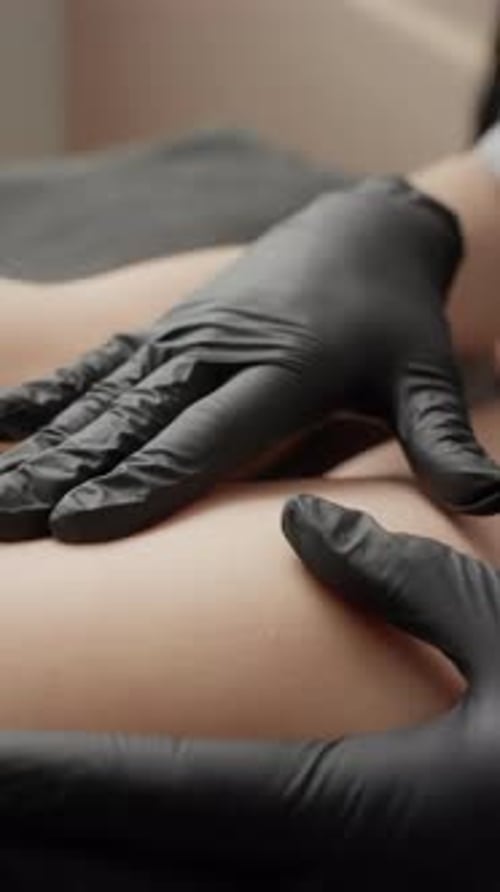 Hands in Gloves Performing Massage