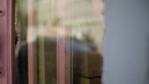 Hand Gripping an Old Wooden Door Handle with Brass Details Closeup Shot