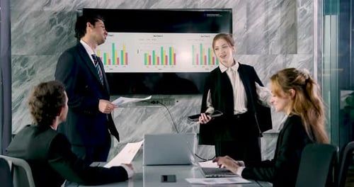 Business Team Meeting with Presentation in Modern Office