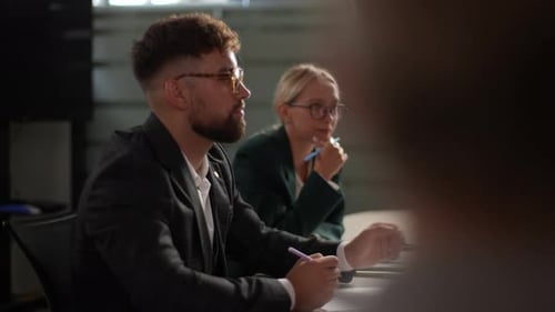 Side View of Serious Businessman Signing Trust Partnership Contract at Group Meeting with Business