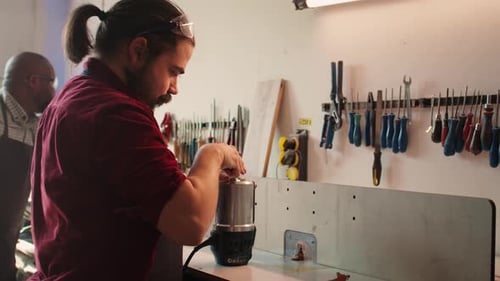 Mechanic in Carpentry Shop Changing Rotor Part on Spindle Moulder