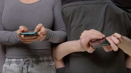 People using smartphones in a studio close up