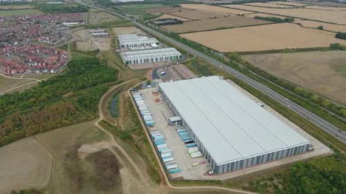 Overhead video of industrial warehouse and distribution yard in Bedford UK, showing heavy trucks