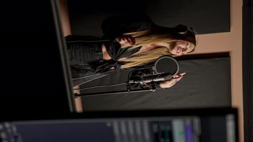 On the sound engineer's computer monitor sound tracks for mixing a new soundtrack that girl sings