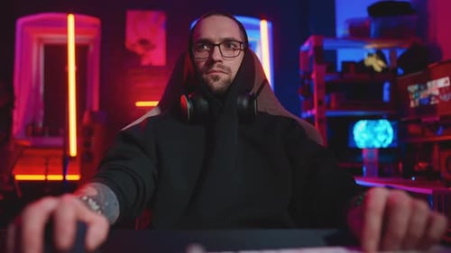 Young Adult Gamer Playing Video Games At Night