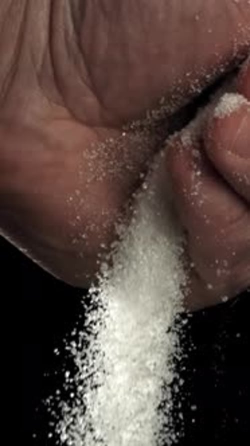 Sugar is Pouring Out of His Hands Filmed on a Highspeed Camera at 1000 Fps