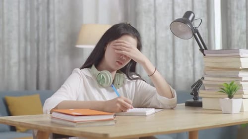Tired Teenager Having Headache While Learning At Home