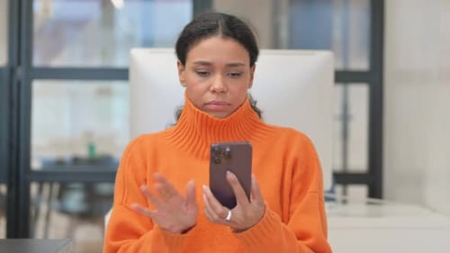 Woman Uses Smartphone in Bright Office Setting