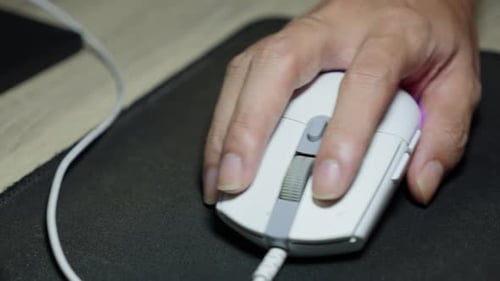 Hand clicks mouse, smoothly guiding its movements across the screen
