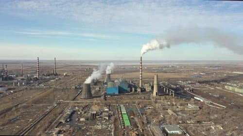 Aerial View of Thermal Power Plant Drone Flies Over Chimney Smoke Pipes and Cooling Towers of