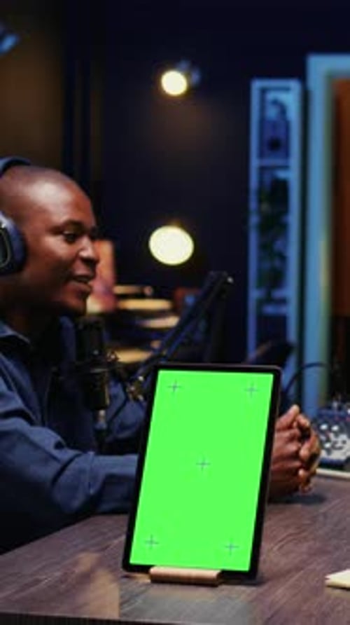 Vertical Video Chroma Key Device on Table with Man and Woman Sitting and Discussing on Podcast