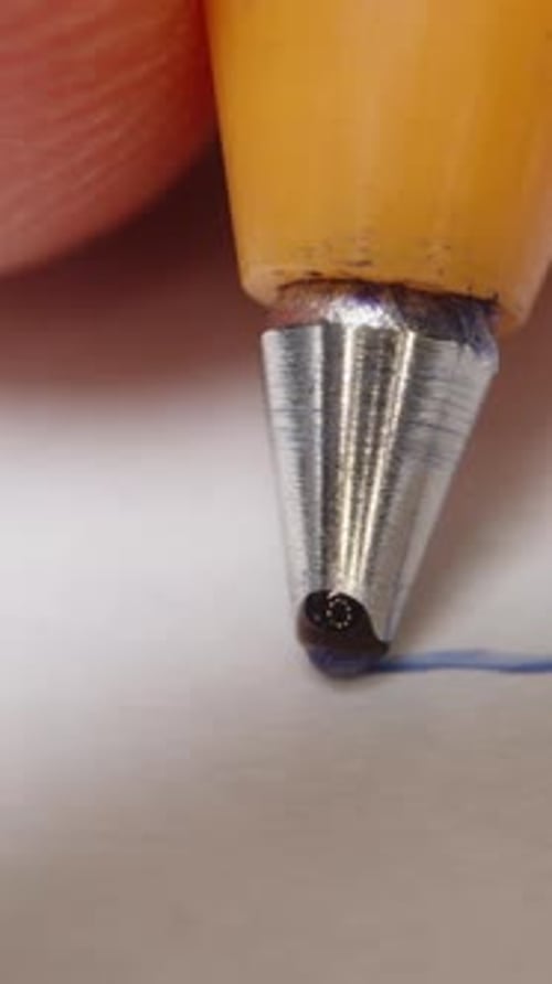 Vertical video. First-person view, the camera follows the ballpoint pen as the man draws a straight