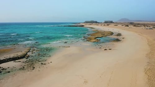 Aerial View of Beach and Ocean on Sunny Day